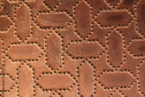 Metal door pattern of Nasrid Palaces (Palacios Nazaries) at the historical Alhambra Palace complex in Granada, Andalusia, Spain.