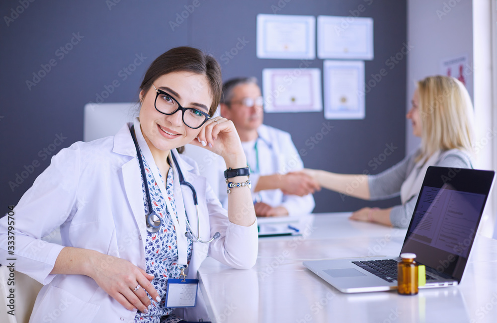 Doctor and patient discussing something while sitting at the table . Medicine and health care concept Doctor and patient discussing something while sitting at the table . Medicine and health care concept