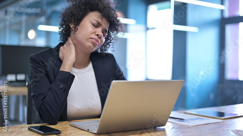 Photos Tired African Businesswoman having Neck Pain at Work