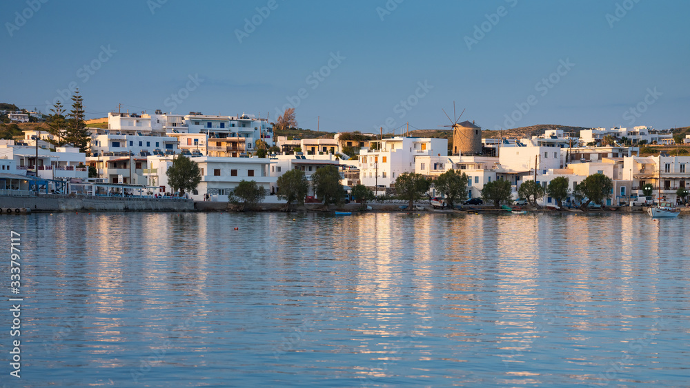 panoramic view to greek city on the Mylos island with view to old wind mill