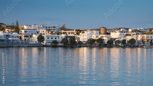 panoramic view to greek city on the Mylos island with view to old wind mill
