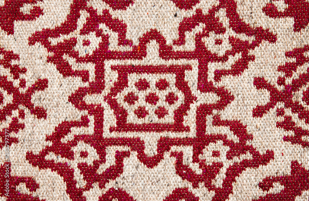 Old ornament on the carpet. The old carpet.