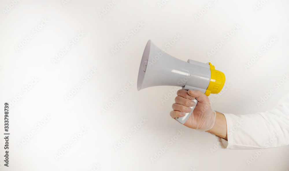 gloved hands using megaphone, with copy space gloved hands using megaphone, with copy space