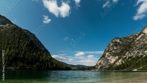 Pragser Wildsee seen from the beach as the clouds move around painting the blue sky