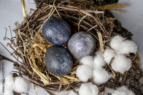 space easter eggs lie in a nest in the hay, with cotton