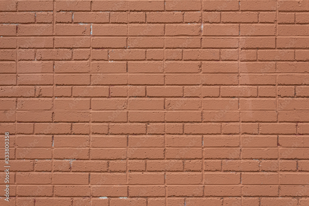 Fototapeta premium Orange painted brick wall background with alternating running bond and jack bond brick pattern, horizontal aspect