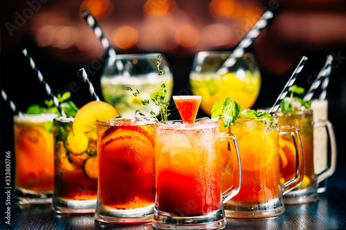 Several glasses of different drinks on bright background