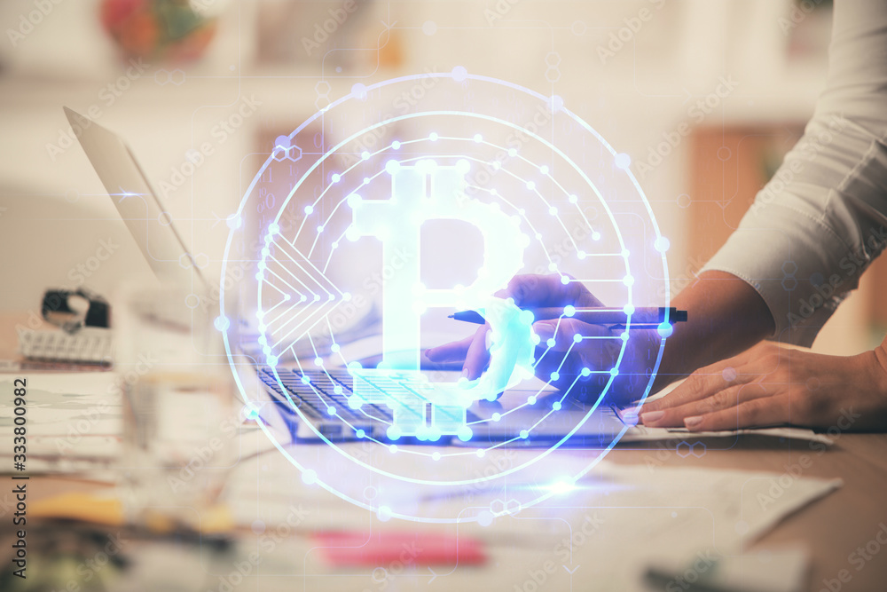 Double exposure of woman hands typing on computer and crypto market theme hologram drawing. Blockchain concept. Double exposure of woman hands typing on computer and crypto market theme hologram drawing. Blockchain concept.