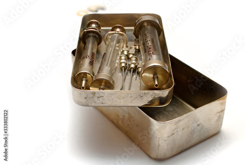 Фотография Glass syringes and needles of the 20th century in a metal box for sterilization
