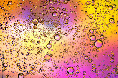 drops of oil on water and colorful blurred background