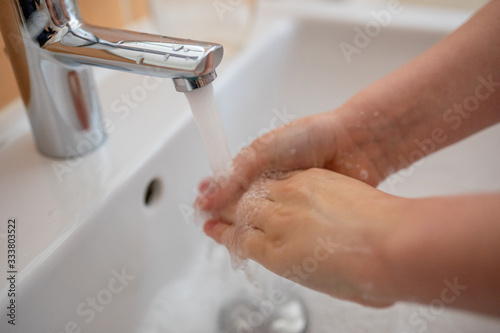 washing hands with foaming antibacterial soap applying hand disinfectant