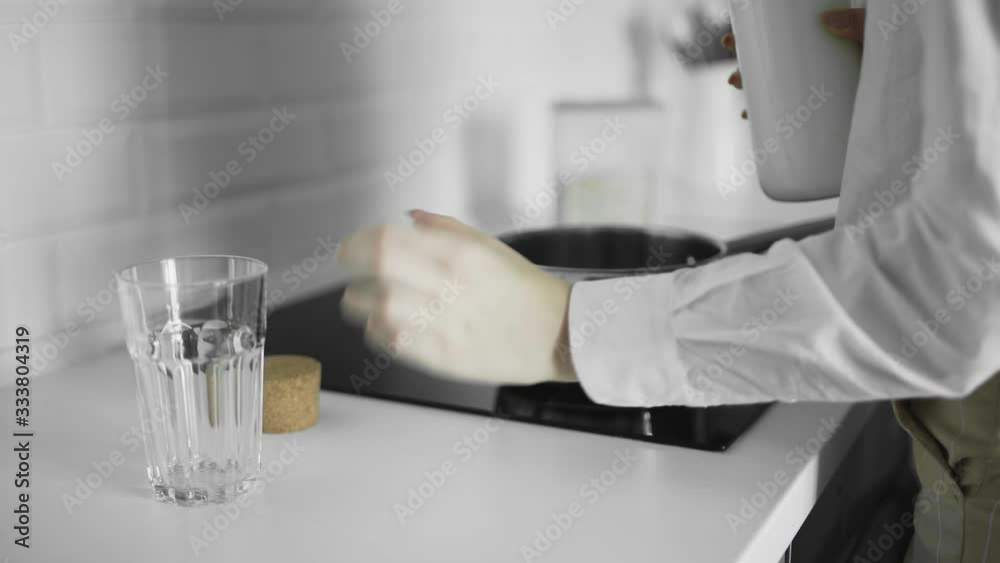 Cook natural organic milk, boil the milk in pots, milk being poured into a pan Cook natural organic milk, boil the milk in pots, milk being poured into a pan