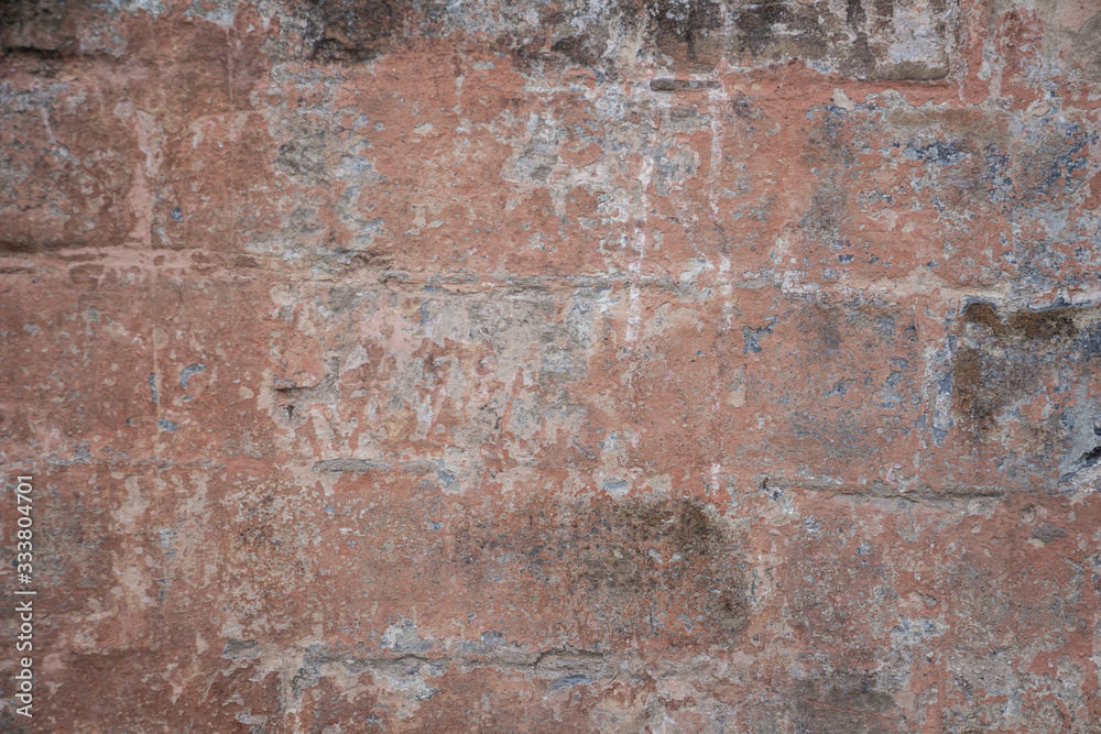 old brick wall with several layers of peeling paint old brick wall with several layers of peeling paint