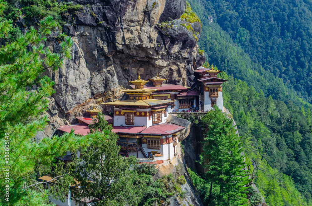 The sacred Buddhist monastery, known as Tiger's Nest, perched on the cliff of mountains of Paro, Bhutan The sacred Buddhist monastery, known as Tiger's Nest, perched on the cliff of mountains of Paro, Bhutan