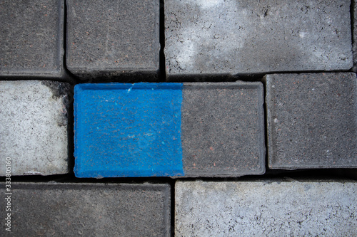 background of gray bricks with a blue highlighted square