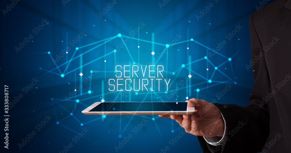 Fototapeta premium Young business person working on tablet and shows the digital sign: SERVER SECURITY