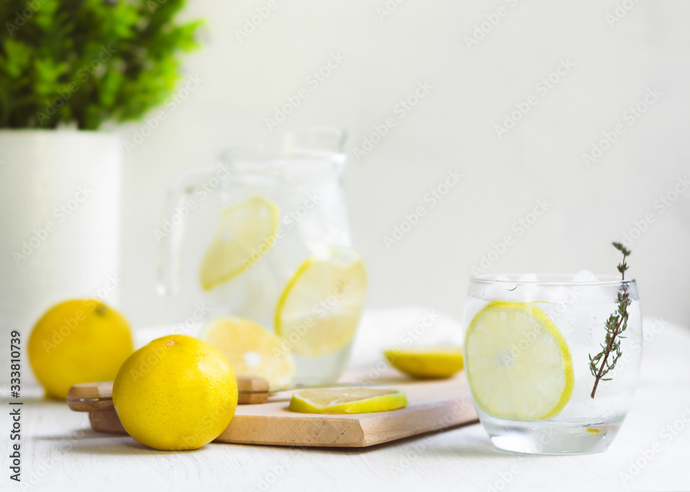 Fototapeta premium Fresh Sweet Lemonade Water; knife, wood and some plants