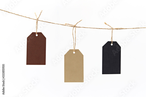 Blank tag hanging on string isolated on white background