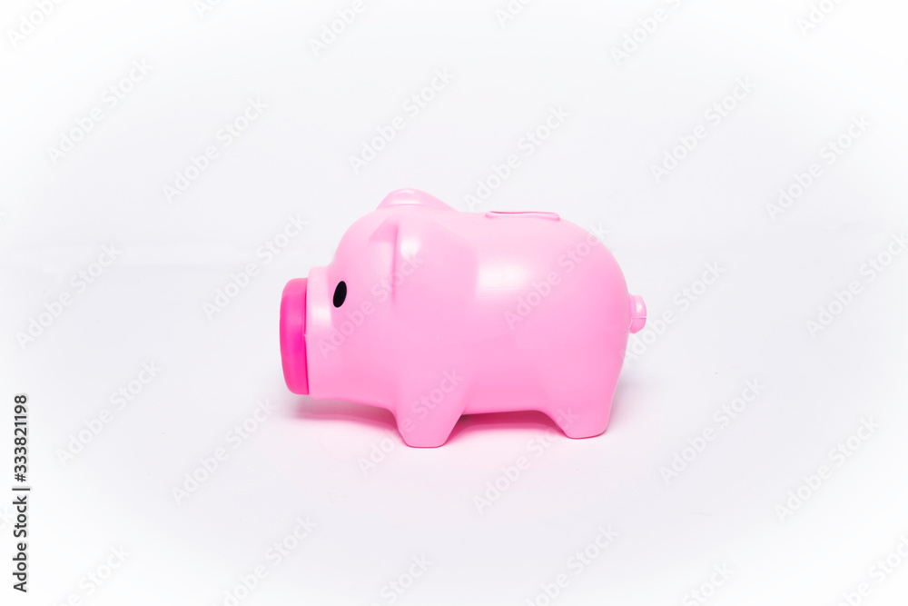A pink piggy bank on the side of a white background