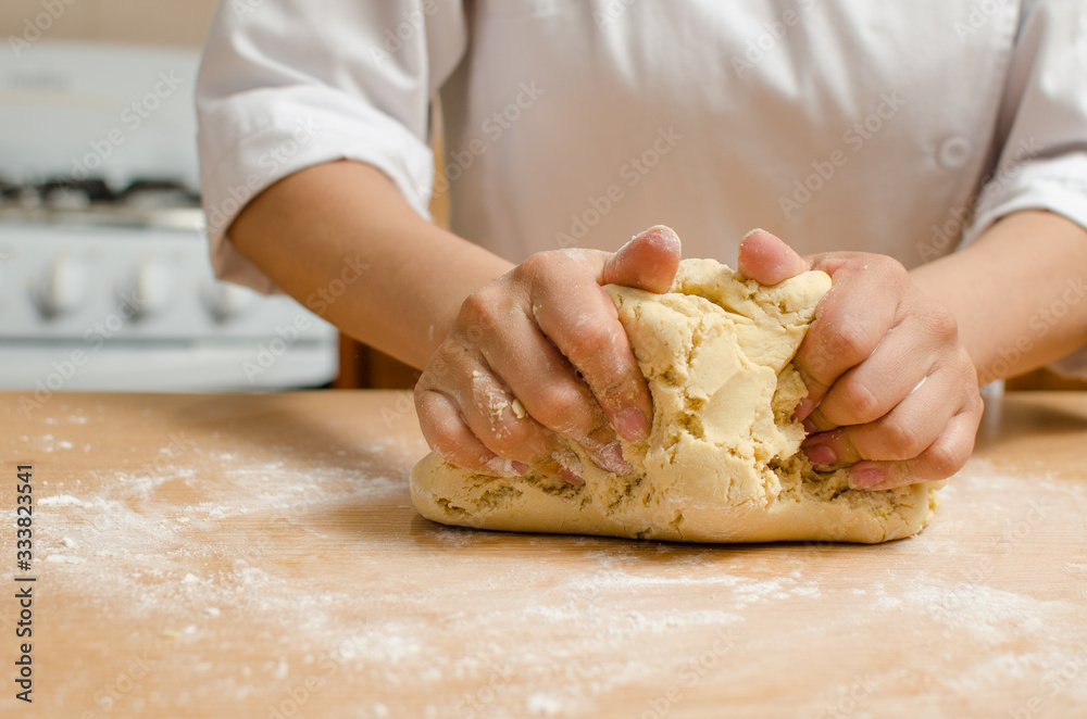 hands kneading dough