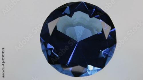 Rotation of a large blue diamond on a white background. Top view.