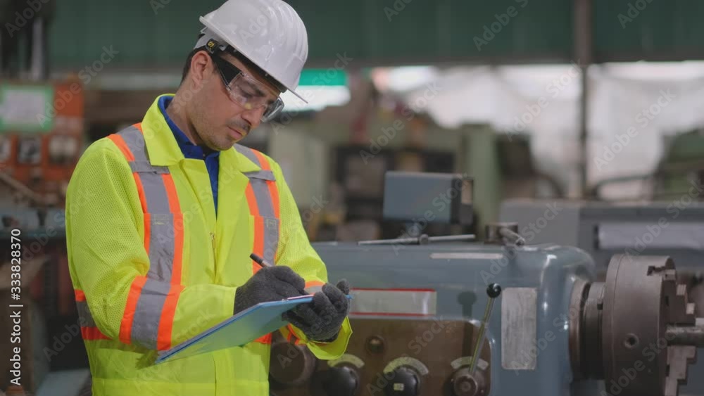 Technician or factory worker man with white helmet and bright yellow uniform check and maintenance the machine in factory. Technician or factory worker man with white helmet and bright yellow uniform check and maintenance the machine in factory.