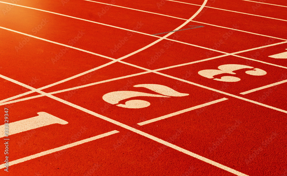 Stadium running track with red coating and numbers closeup