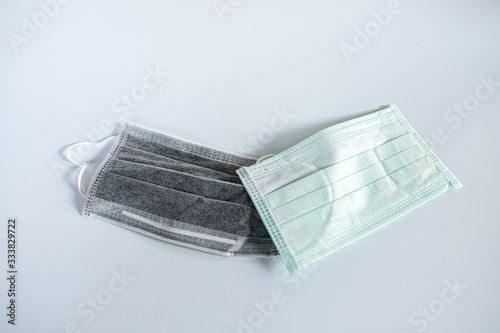 Used Medical mask for protection Covid virus ,against flu and other diseases on white background.