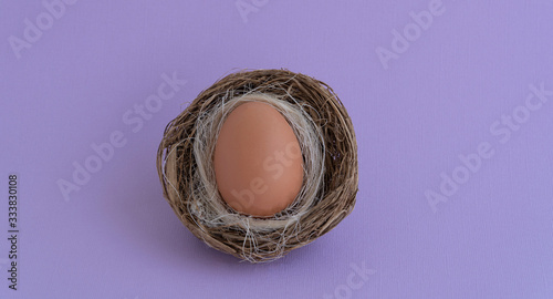 test with eggs on a light purple background, happy Easter. Top view, copy space for text.