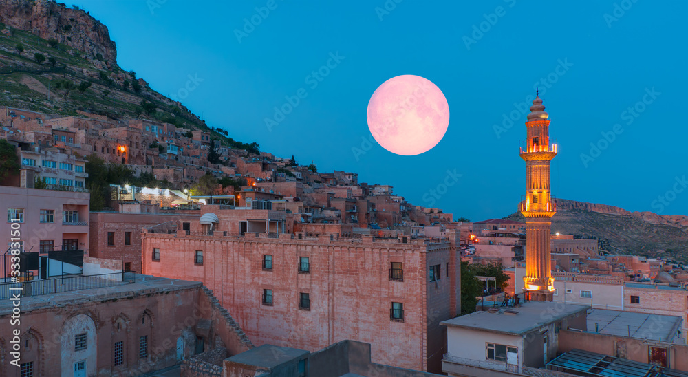 Sehidiye mosque with ful moon - Mardin old town at dusk. Historical beige colored limestone rock buildings "Elements of this image furnished by NASA " - obrazy, fototapety, plakaty 