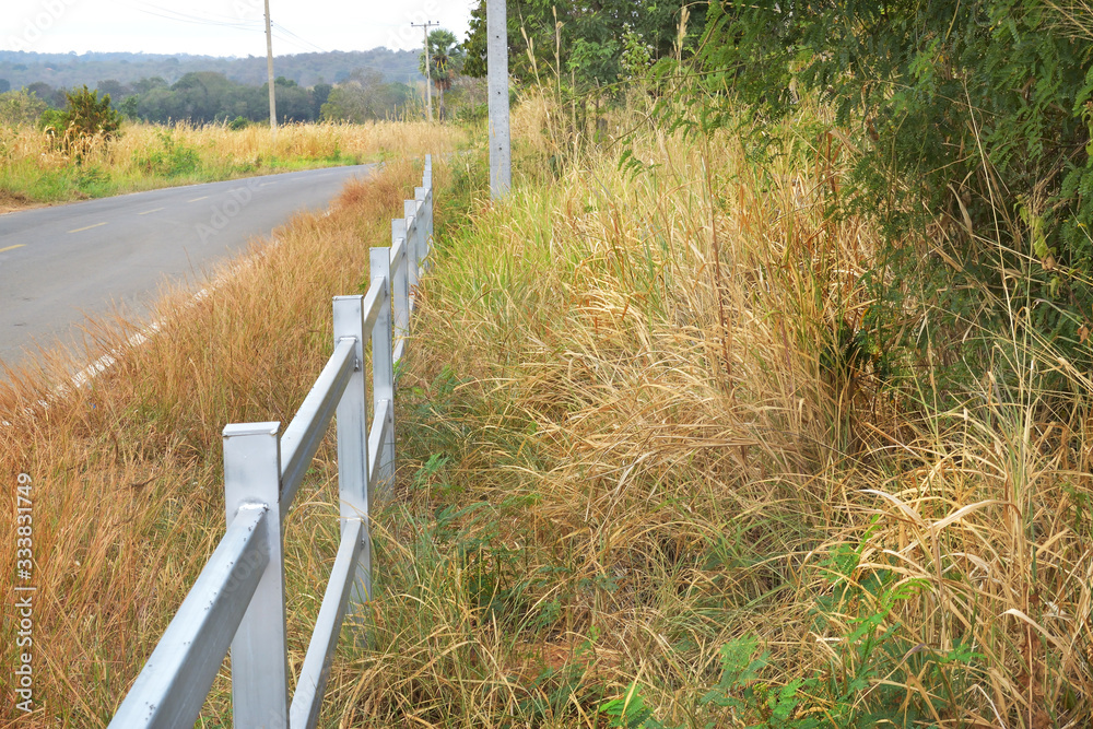 White picket fence installed on the side of the road