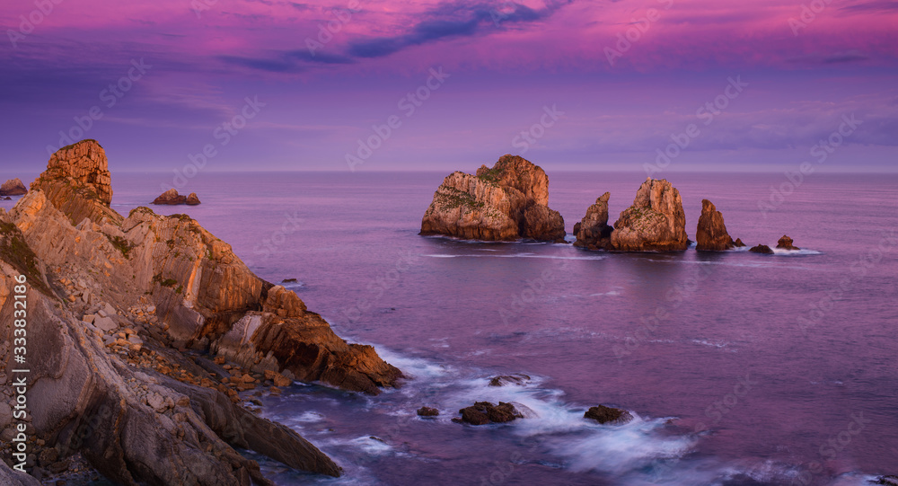 Incredible cliffs on the coast near the village of Liencres before sunrise. Cantabria. Northern coast of Spain