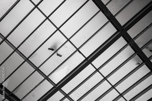 Black and white conceptual art photograph with feet of people who shine through a translucent floor. Santander, the capital of Cantabria.Northern spain