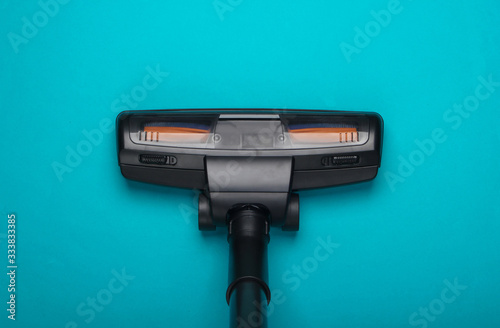 Vacuum cleaner brush on a blue background. Top view. Cleaning concept.