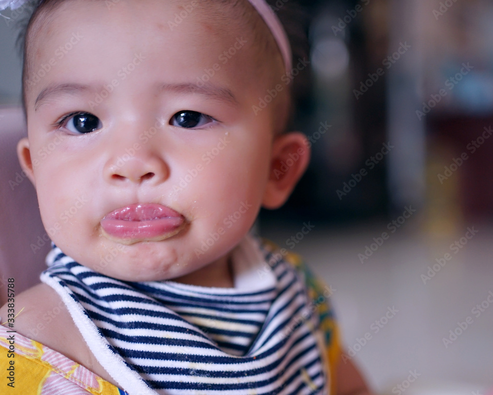 Infant girls eating mashed potatoes mixed with water. Infant girls eating mashed potatoes mixed with water.