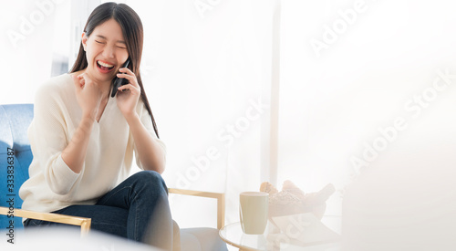 smart attractive asian female woman happy working at home lifestyle freelance or home working with laptop smartphone and book activity ,home quarantine for social distance covid-19 pandemic