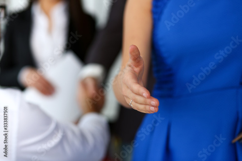 Woman in suit give hand as hello in office closeup. Friend welcome mediation offer positive introduction thanks gesture summit participate executive approval motivation female arm strike bargain