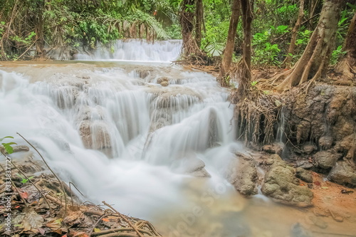 view of silky waterfall around with green forest background, Kroeng Krawia Waterfall, Sangkhla Buri, Kanchanaburi, west of Thailand.