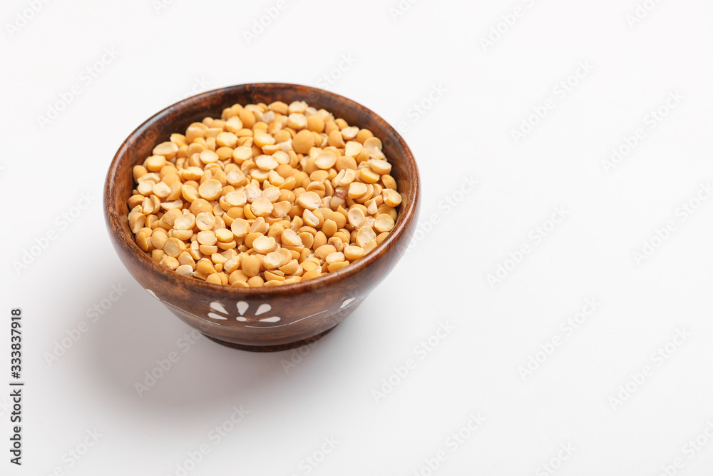 Dried chickpea lentils in wooden bowl on white background , Split Chickpea Also Know as Chana Dal Dried chickpea lentils in wooden bowl on white background , Split Chickpea Also Know as Chana Dal