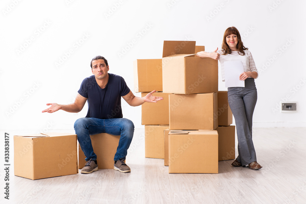 Young pair and many boxes in divorce settlement concept Young pair and many boxes in divorce settlement concept