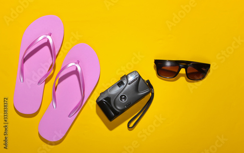Summer vacation concept, travel. Beach accessories and stuff on a yellow background. Studio shot. Flat lay