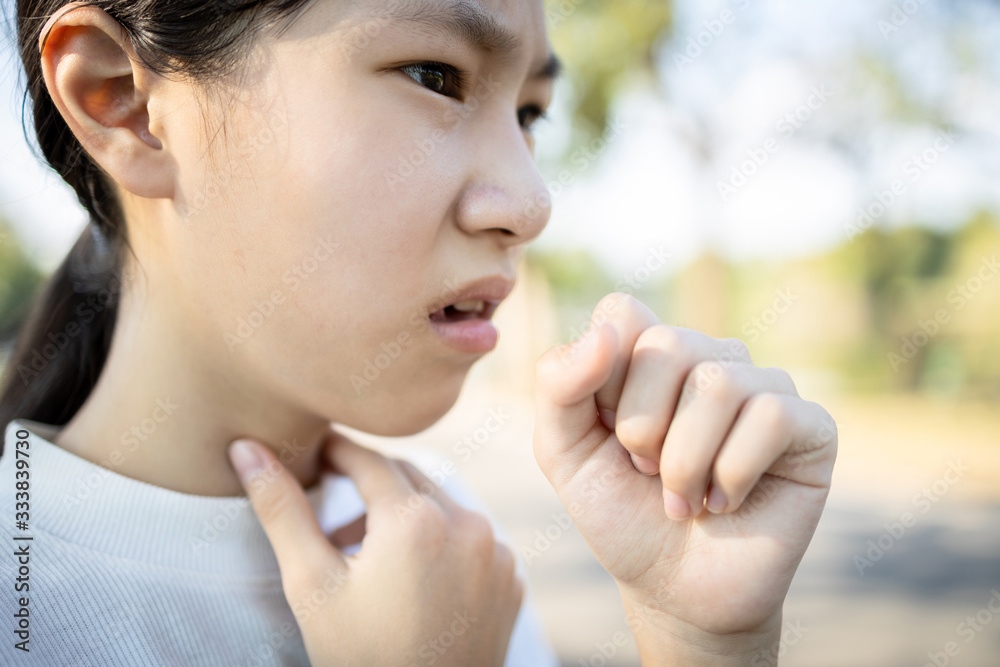 Sick asian woman has a chronic cough with tonsillitis,ill child girl