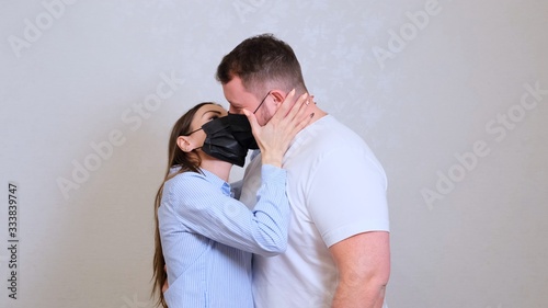 female and male kiss in protective masks. Hygiene concept. prevent the spread of germs and bacteria and avoid infection with the crown virus © Евгения Медведева