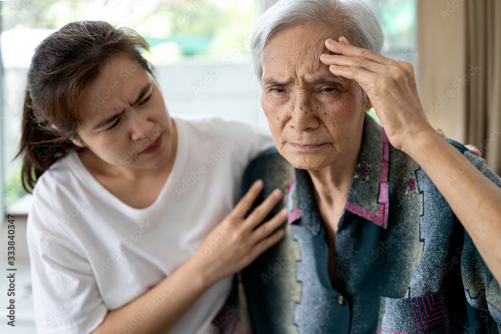 Exhausted tired asian senior woman touching head with her hands, ill elderly  has vertigo,dizziness,sick old people suffering from severe headache,chronic  migraine,brain tumor,hypertension,brain canc Photos
