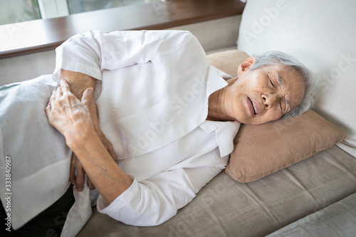 Sick asian senior woman with stomach ache,old people having aching belly,hands touching stomach painful,gastritis,gastric ulcer,severe pain,chronic abdominal problems,colorectal cancer,elderly disease