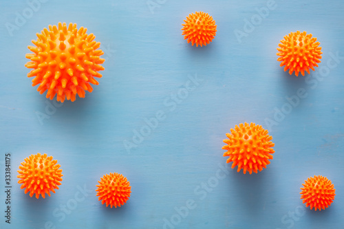 Abstract virus strain orange model of Coronavirus disease COVID-19 on blue wooden background with copy space. Virus Pandemic Protection Concept