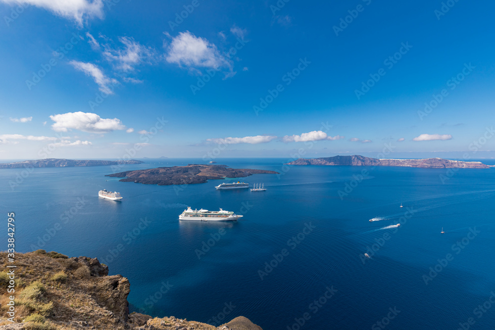 Beautiful landscape with sea view. Cruise ships at the sea near the islands. Santorini island, Greece.
