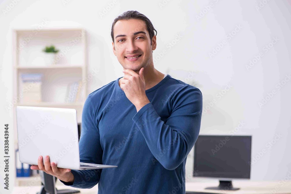 Young male it specialist working in the office Young male it specialist working in the office
