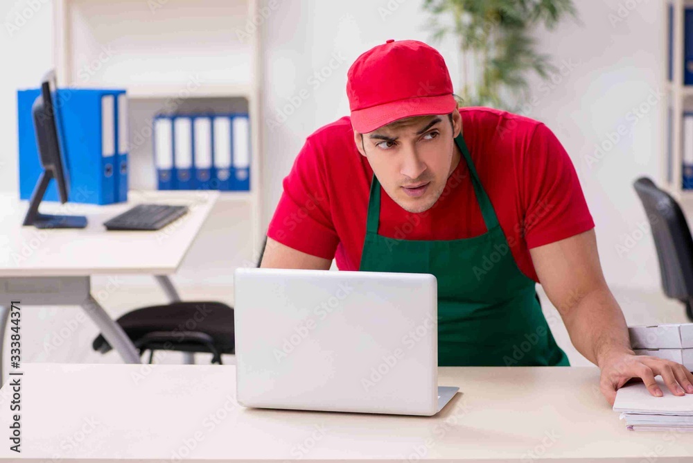 Young male pizza courier in industrial espionage concept Young male pizza courier in industrial espionage concept
