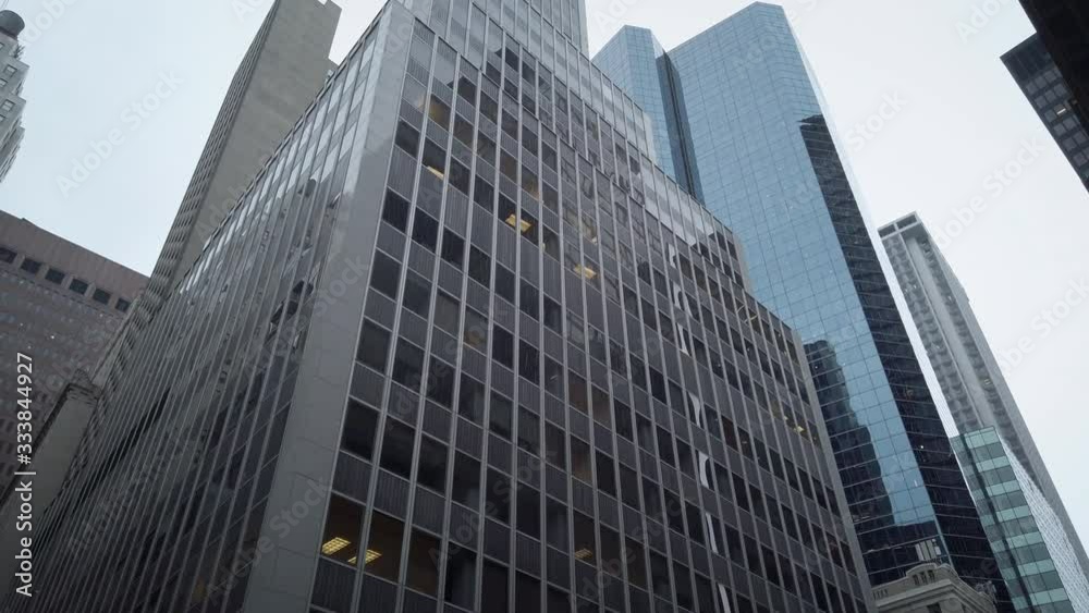 Skyscrapers and office buildings in New York City lower Manhattan's Financial Districit. Low angle view. Multiple buildings from the street looking up. Skyscrapers and office buildings in New York City lower Manhattan's Financial Districit. Low angle view. Multiple buildings from the street looking up.